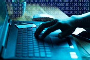 The concept of credit card theft. Hackers with credit cards on laptops use these data for unauthorized shopping. Unauthorized payments from credit card owners. In the hacker's secret office The concept of credit card theft. Hackers with credit cards on laptops use these data for unauthorized shopping. Unauthorized payments from credit card owners. In the hacker's secret office